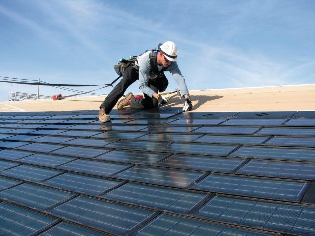 Roofer installing solar panels